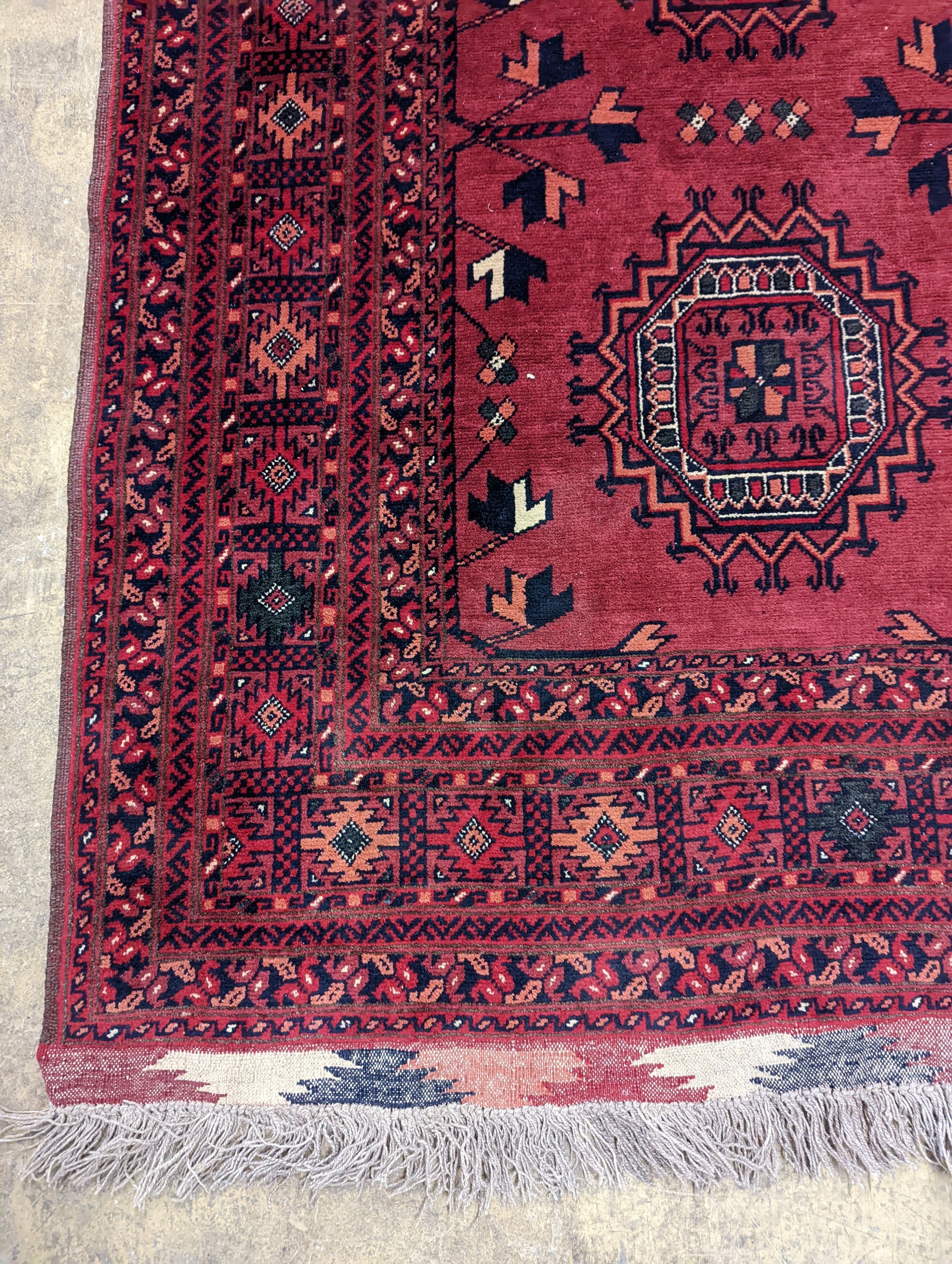 A Bokhara burgundy ground rug, 150 x 106cm